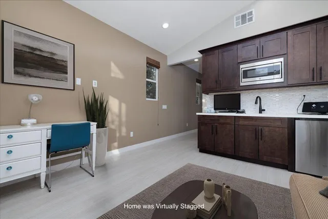 a front view of a house with a yard and mountain view