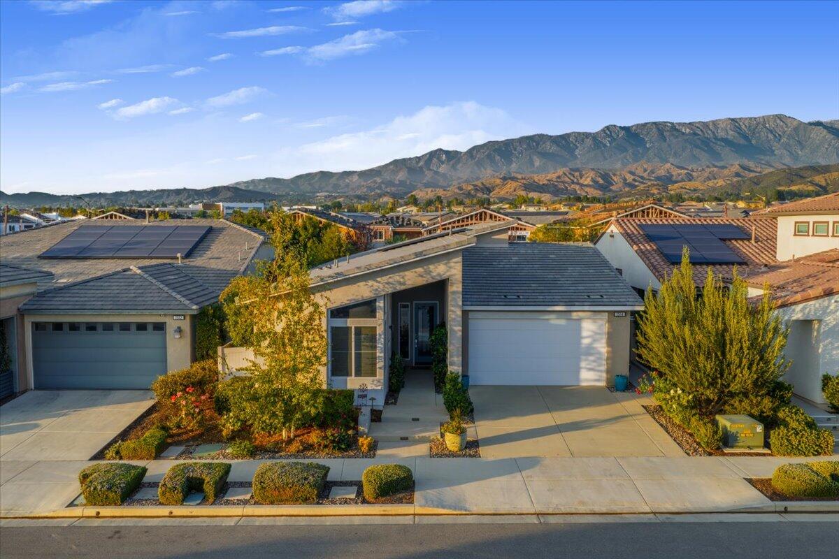 1514 Overpark Lane Beaumont, CA 92223 - Photo 37 of 76 a front view of a house with a yard and mountain view