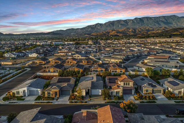an aerial view of residential houses with outdoor space