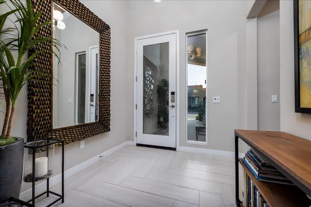 a view of a hallway with furniture and windows