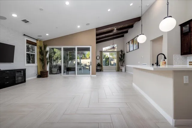 a living room with fireplace furniture and a large window