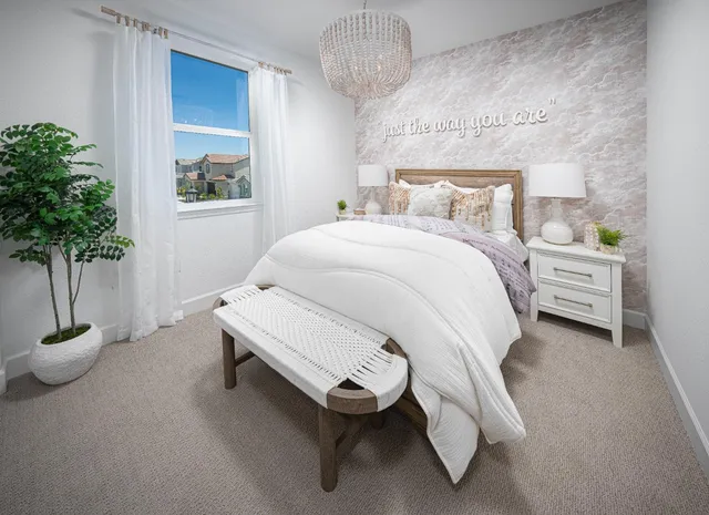 a bedroom with a bed and a potted plant