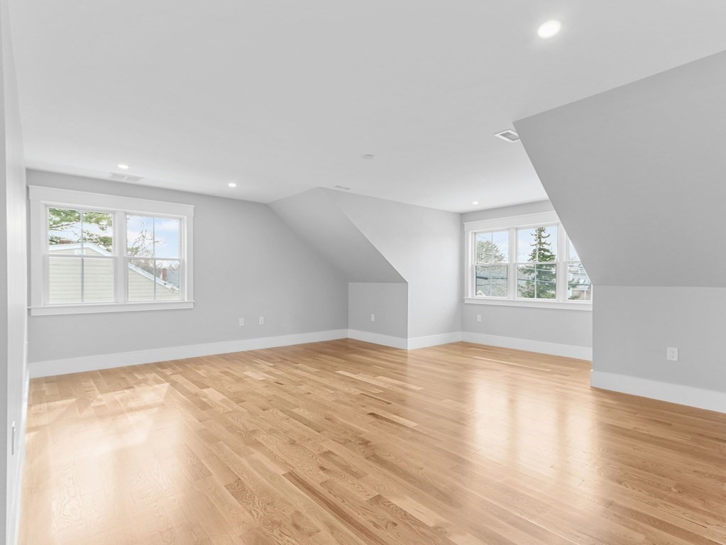 138 Lexington Street Newton, MA 02466 - Photo 13 of 27 an empty room with wooden floor and windows