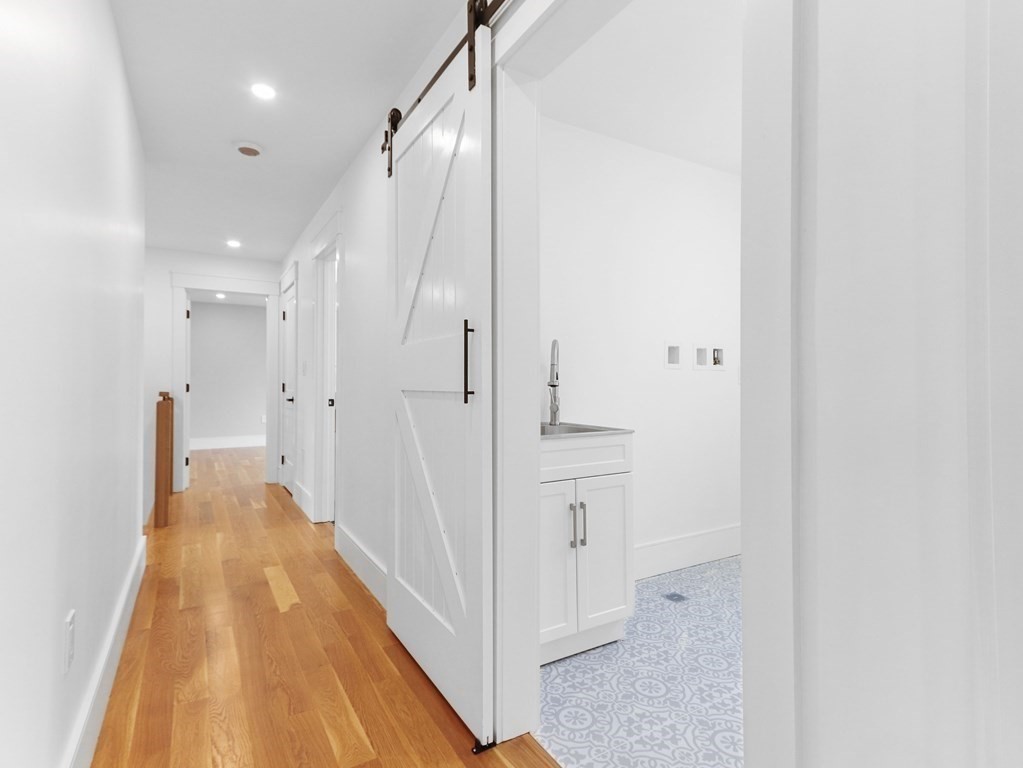 138 Lexington Street Newton, MA 02466 - Photo 15 of 27 a view of a hallway with white walls