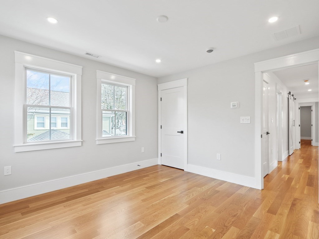 138 Lexington Street Newton, MA 02466 - Photo 16 of 27 a view of empty room with wooden floor and fan