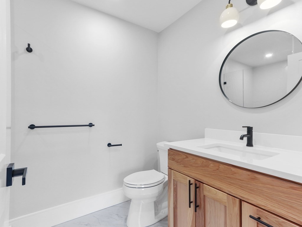 138 Lexington Street Newton, MA 02466 - Photo 20 of 27 a bathroom with a sink a toilet and a mirror