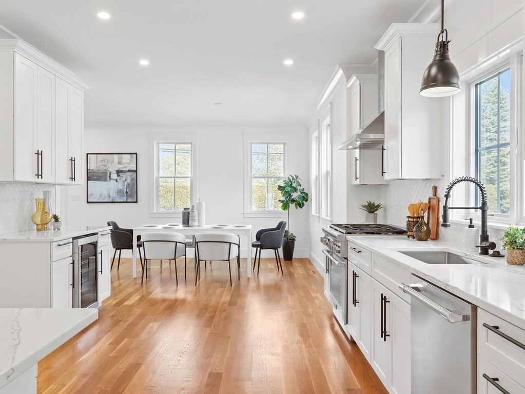 138 Lexington Street Newton, MA 02466 - Photo 2 of 27 a open kitchen with stainless steel appliances granite countertop a dining table chairs stove a sink and white cabinets with wooden floor