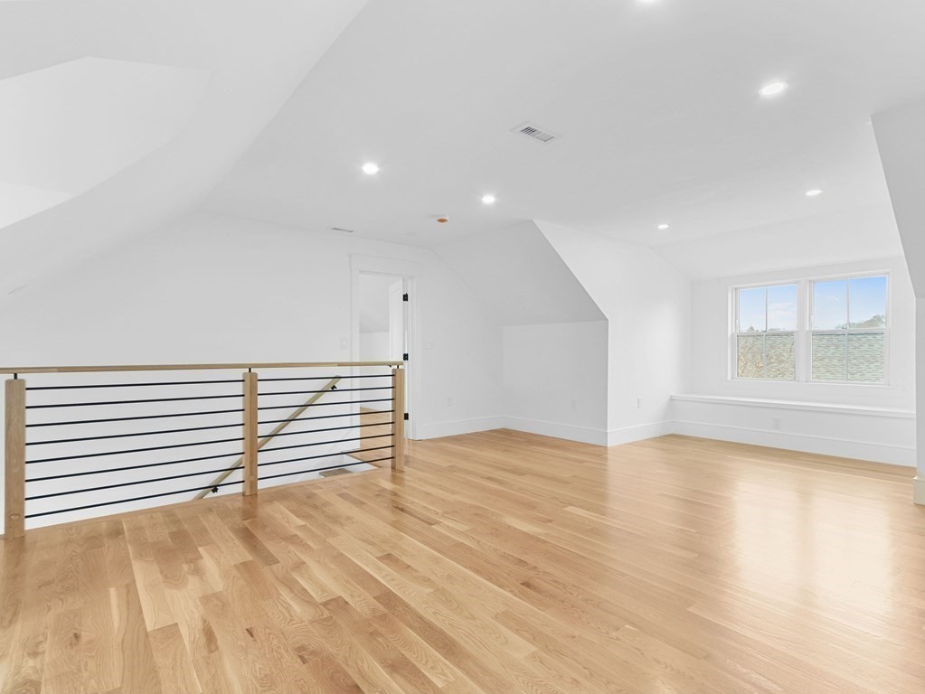 138 Lexington Street Newton, MA 02466 - Photo 22 of 27 a view of an empty room with wooden floor and a window