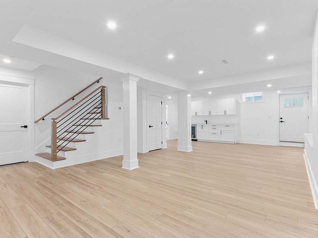 138 Lexington Street Newton, MA 02466 - Photo 23 of 27 a view of an empty room with wooden floor and stairs