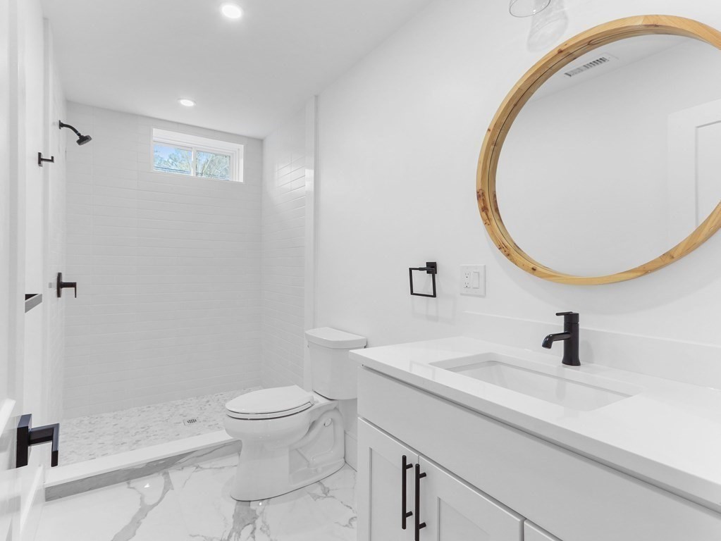138 Lexington Street Newton, MA 02466 - Photo 24 of 27 a bathroom with a sink a toilet and a mirror