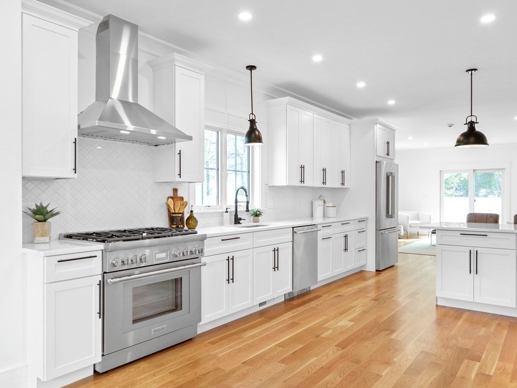 138 Lexington Street Newton, MA 02466 - Photo 3 of 27 a large kitchen with a stove top oven sink and cabinets