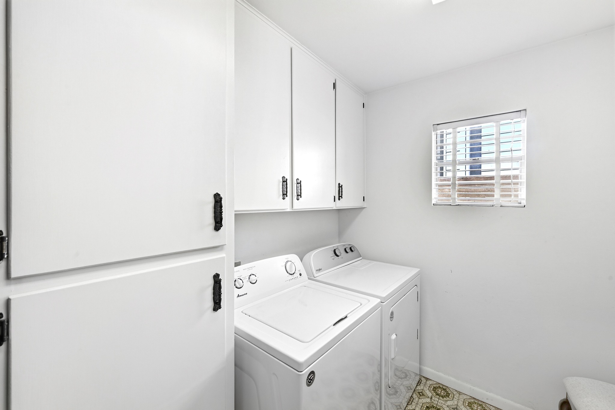 4619 Banister Lane Austin, TX 78745 - Photo 24 of 34 75sf laundry area featuring independent washer and dryer and cabinet space