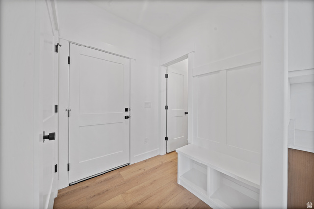 1117 East Shilow Road, Unit 106 Erda, UT 84074 - Photo 17 of 21 Entryway featuring wood-finish flooring, crisp white walls, and contemporary black hardware