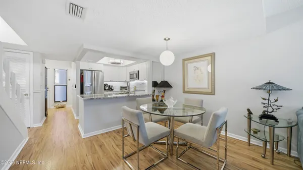 a view of a dining room with furniture and wooden floor