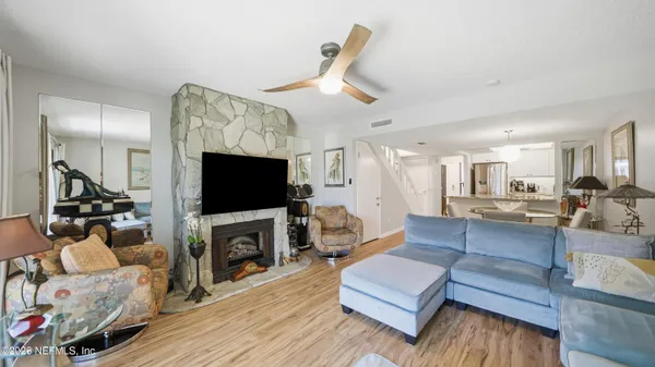 a living room with furniture a flat screen tv and a fireplace