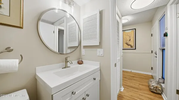 a bathroom with a sink a mirror and a shower