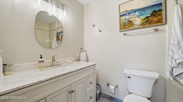 a bathroom with a toilet a sink and a mirror