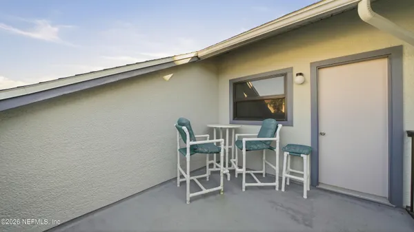 a dining room with a wooden table and chairs