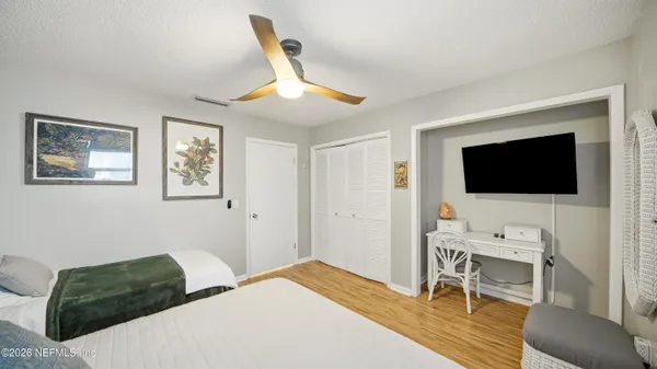 a bedroom with a bed and a flat screen tv