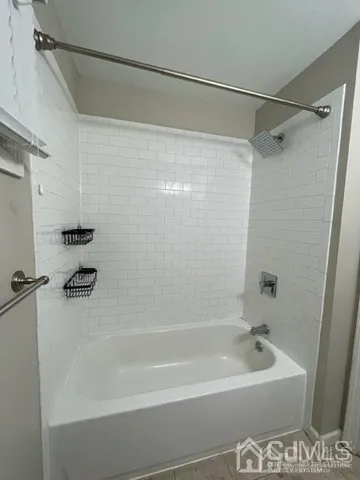 a bathroom with a shower and a bath tub