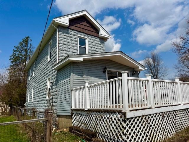 a view of a house with wooden fence