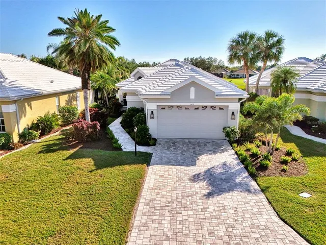 a view of a house with a swimming pool and a yard