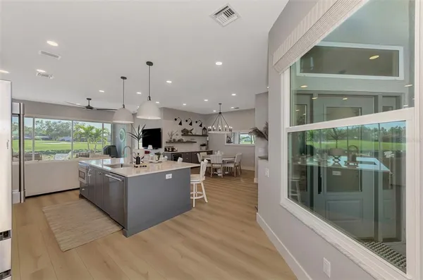 a living room with furniture floor to ceiling window and floor to ceiling window