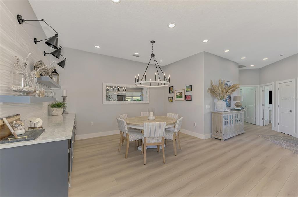 561 Fallbrook Drive Venice, FL 34292 - Photo 19 of 81 a view of a dining room with furniture and wooden floor