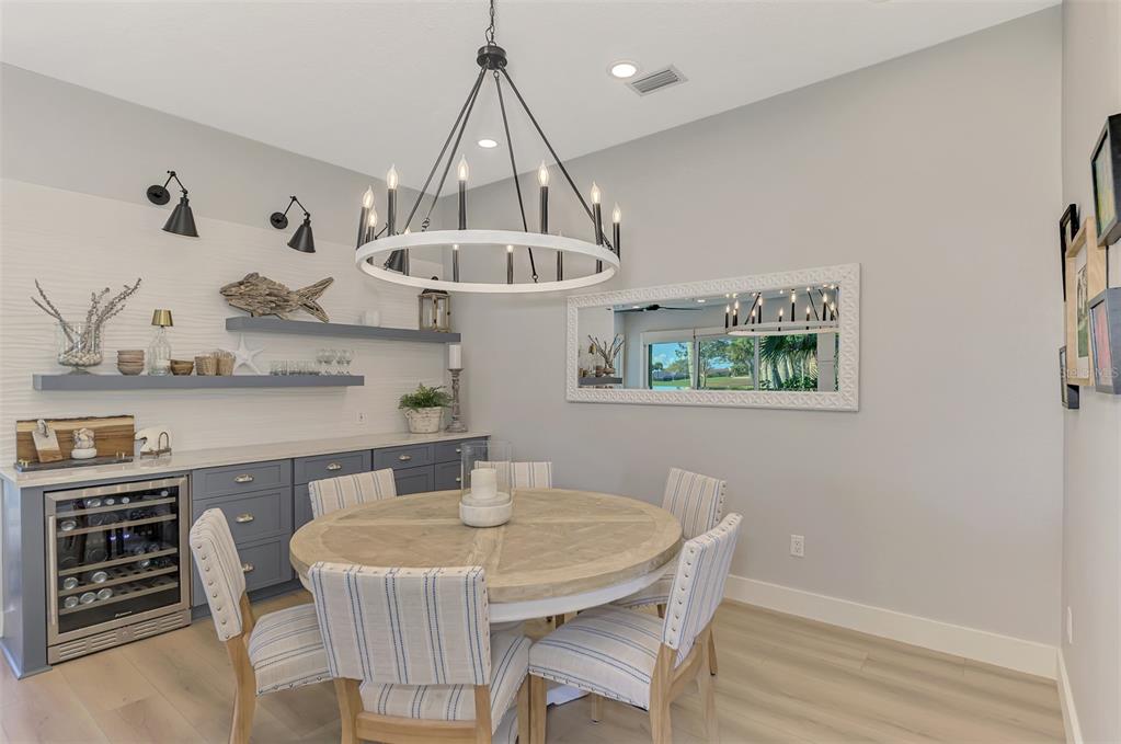 561 Fallbrook Drive Venice, FL 34292 - Photo 20 of 81 a view of a dining room with furniture and wooden floor