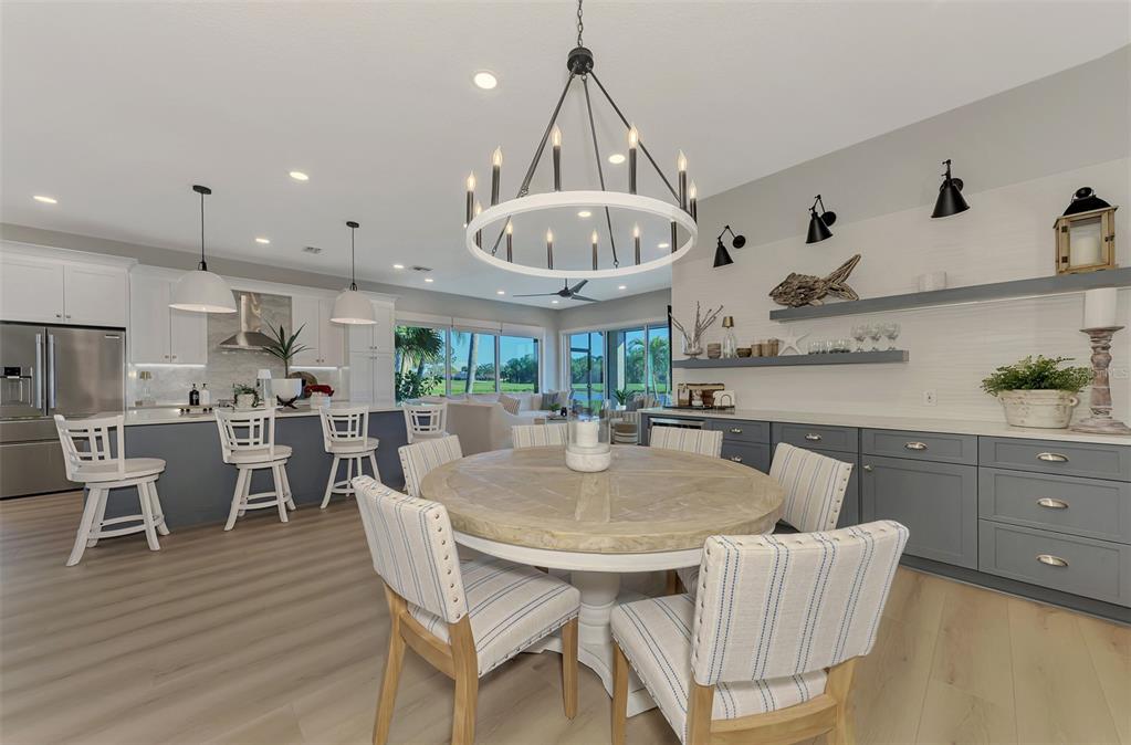 561 Fallbrook Drive Venice, FL 34292 - Photo 21 of 81 a view of a dining room with furniture and wooden floor