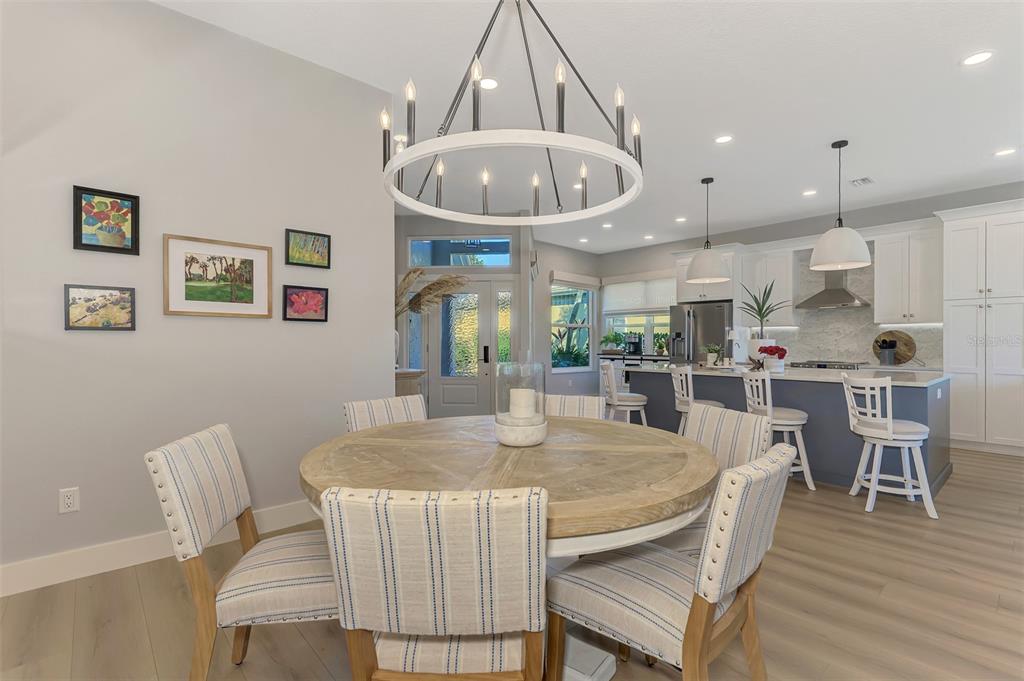 561 Fallbrook Drive Venice, FL 34292 - Photo 22 of 81 a view of a dining room with furniture and wooden floor