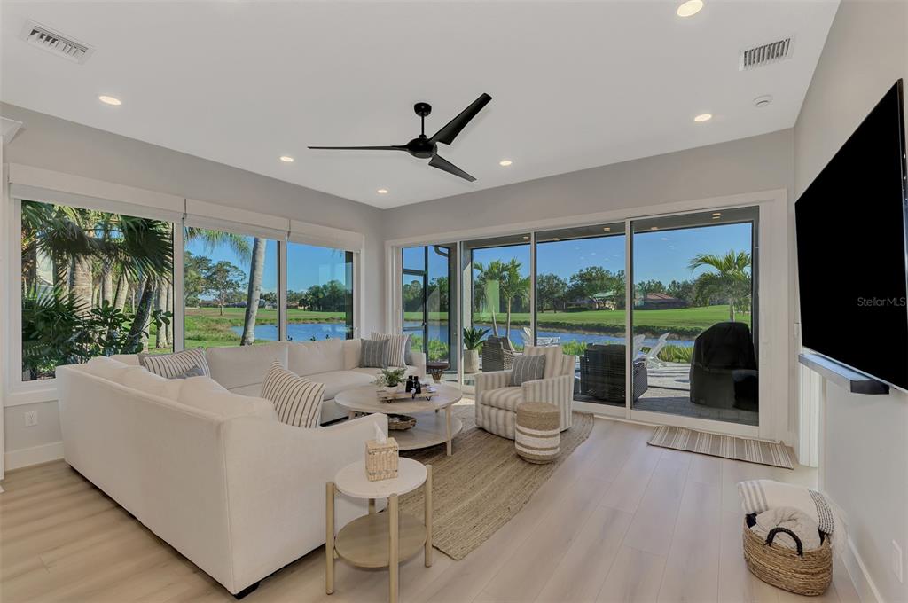561 Fallbrook Drive Venice, FL 34292 - Photo 23 of 81 a living room with furniture floor to ceiling window and floor to ceiling window