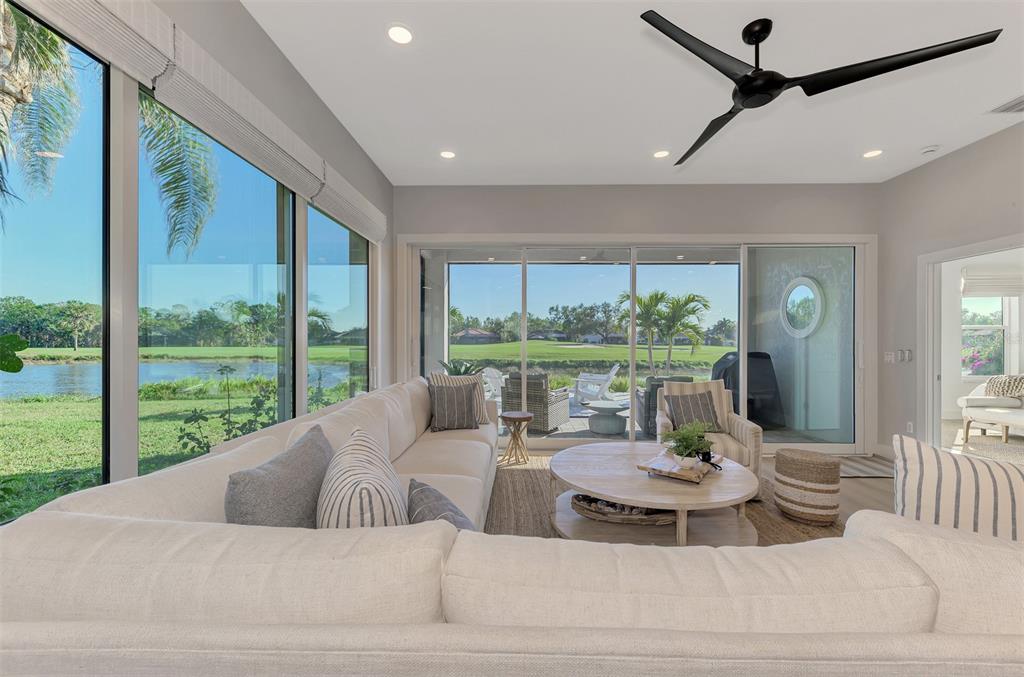 561 Fallbrook Drive Venice, FL 34292 - Photo 24 of 81 a living room with furniture and a floor to ceiling window