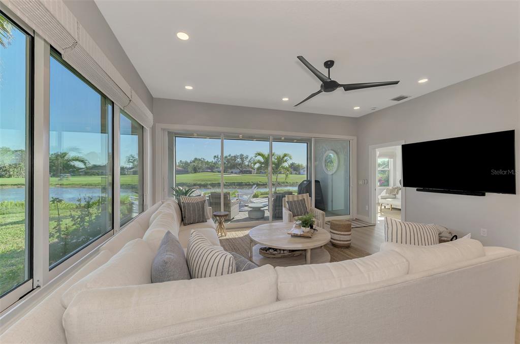 561 Fallbrook Drive Venice, FL 34292 - Photo 25 of 81 a living room with furniture and a flat screen tv