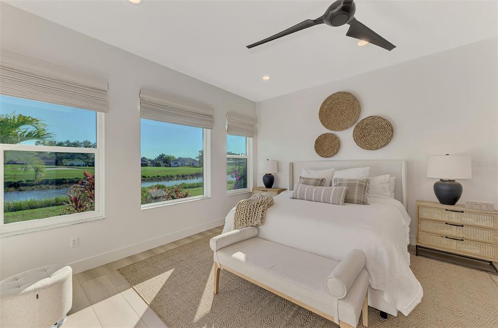 561 Fallbrook Drive Venice, FL 34292 - Photo 28 of 81 a bedroom with a large bed and two large window
