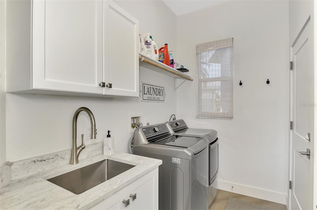 561 Fallbrook Drive Venice, FL 34292 - Photo 40 of 81 a kitchen with stainless steel appliances granite countertop a sink dishwasher and cabinets with wooden floor