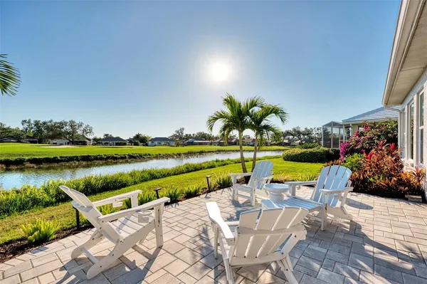 a outdoor space with lots of tables a large window and chairs