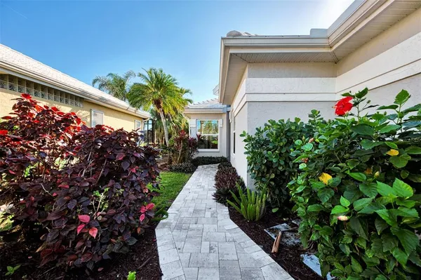 a kitchen with stainless steel appliances granite countertop a refrigerator a sink a stove and a refrigerator with wooden floor