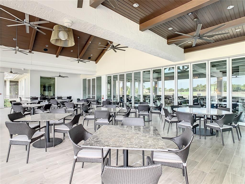 561 Fallbrook Drive Venice, FL 34292 - Photo 73 of 81 a outdoor space with lots of tables a large window and chairs