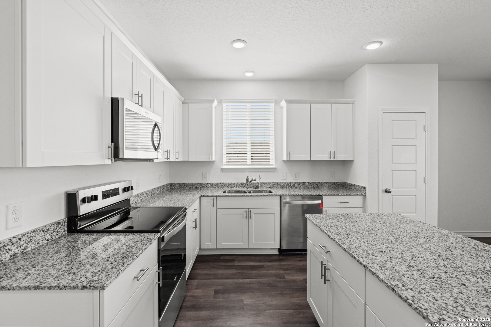4068 Paddock Trail Seguin, TX 78155 - Photo 16 of 34 a kitchen with stainless steel appliances granite countertop a sink stove and cabinets