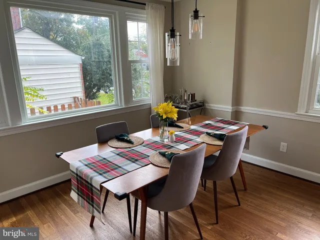 a view of a dining room with furniture and a window