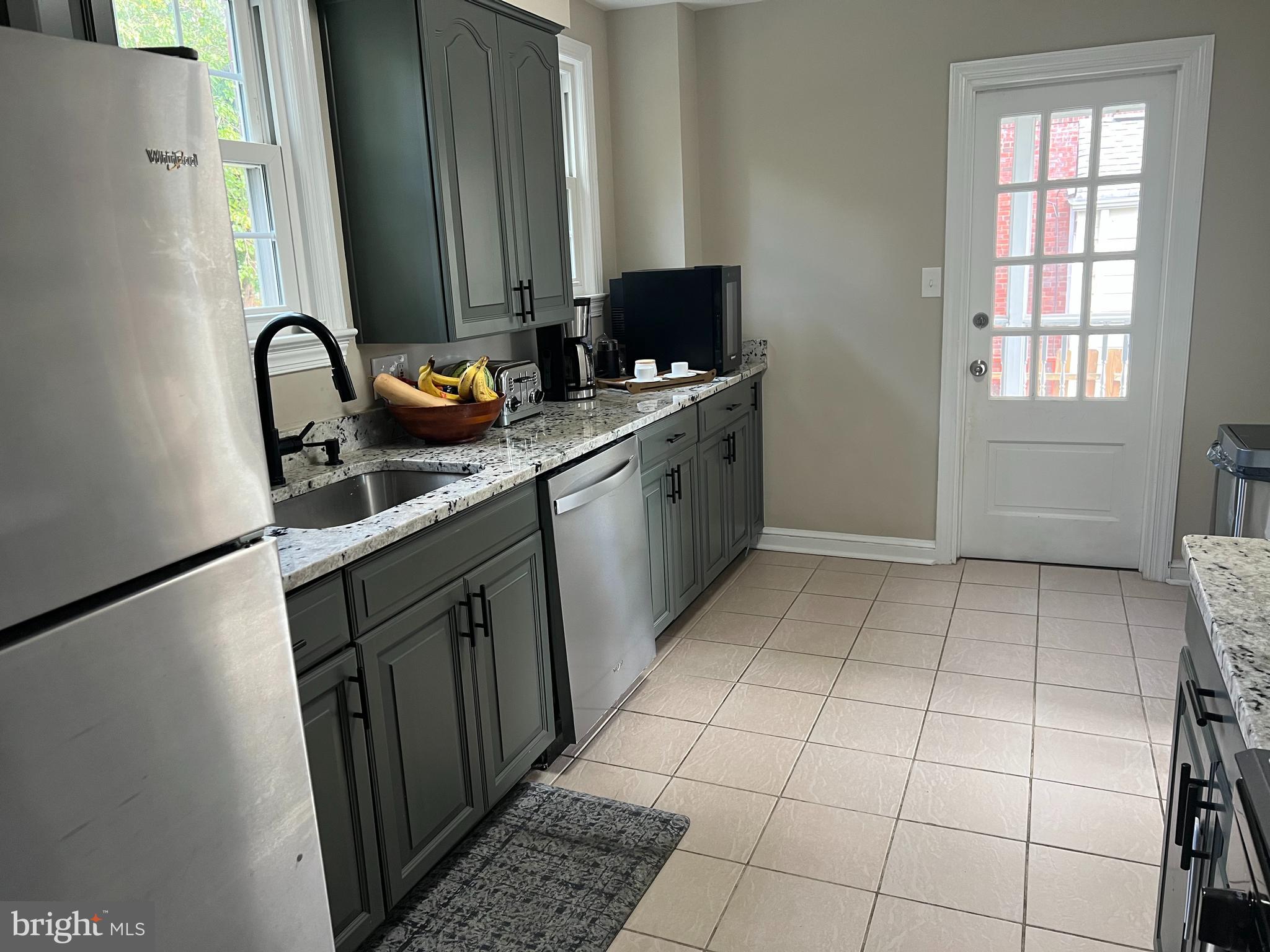 405 Gilmoure Drive Silver Spring, MD 20901 - Photo 23 of 53 a kitchen with stainless steel appliances a sink a stove and a refrigerator