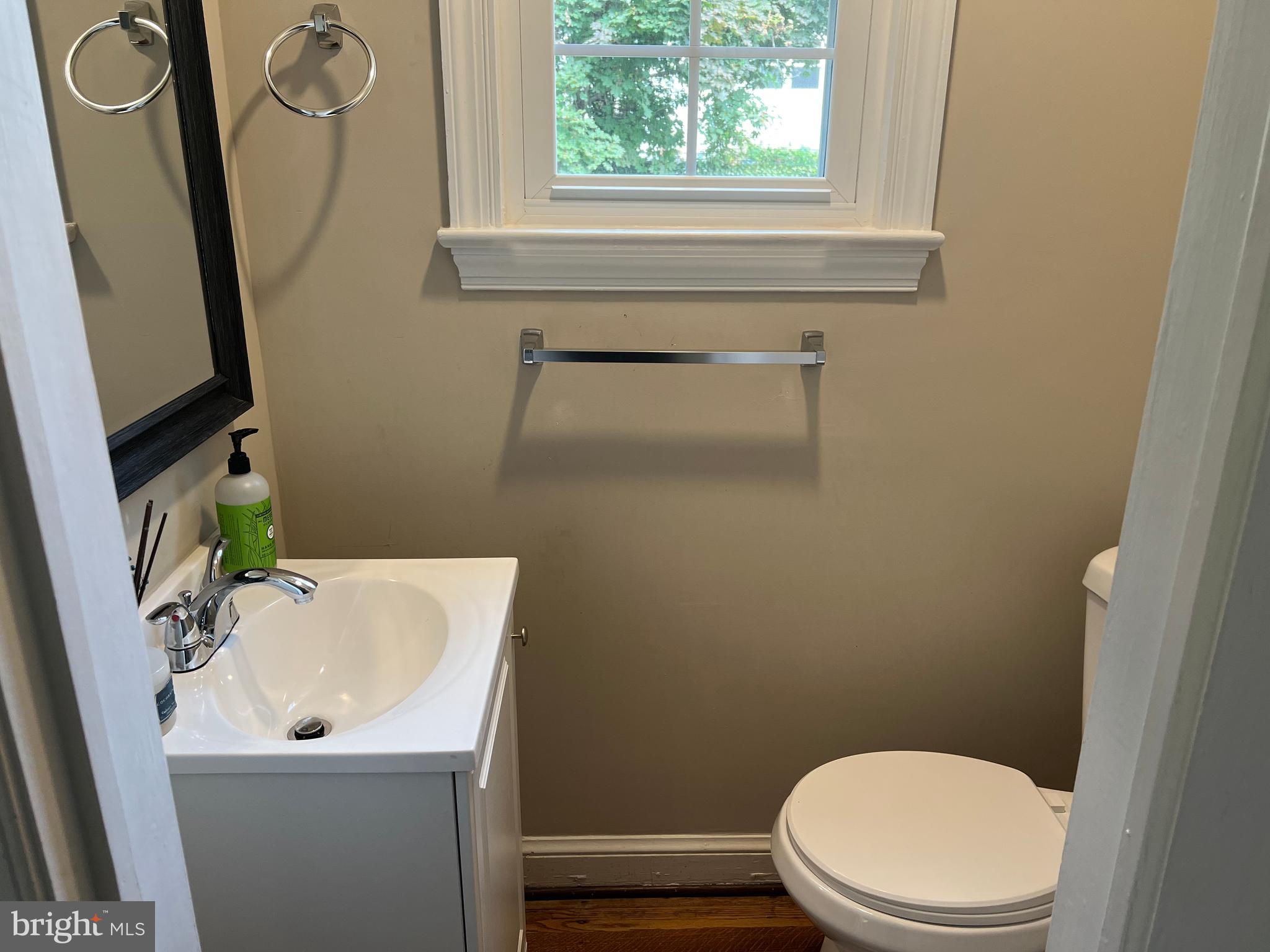 405 Gilmoure Drive Silver Spring, MD 20901 - Photo 26 of 53 a bathroom with a sink a toilet and mirror