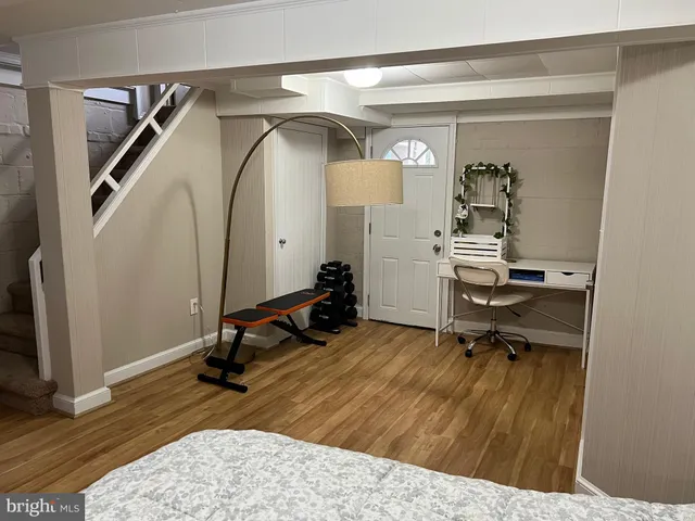 a bedroom with a bed a desk and chair