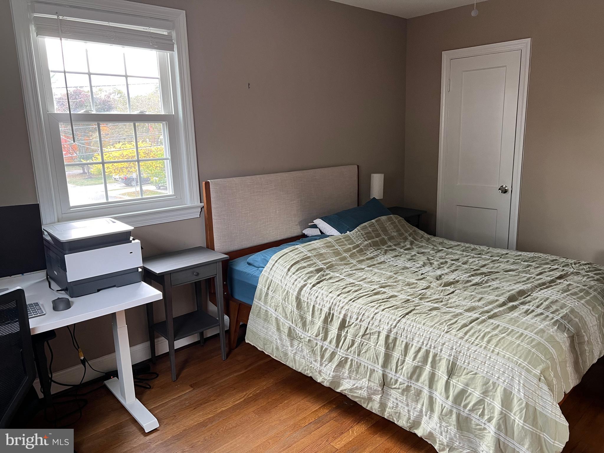 405 Gilmoure Drive Silver Spring, MD 20901 - Photo 32 of 53 a bedroom with a bed a desk and chair