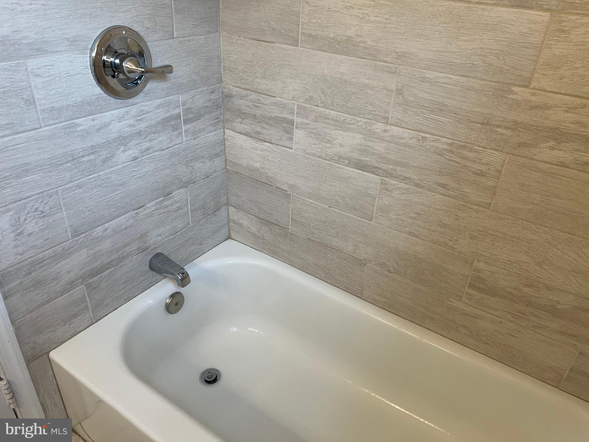 405 Gilmoure Drive Silver Spring, MD 20901 - Photo 36 of 53 a bathroom with a tub and a shower