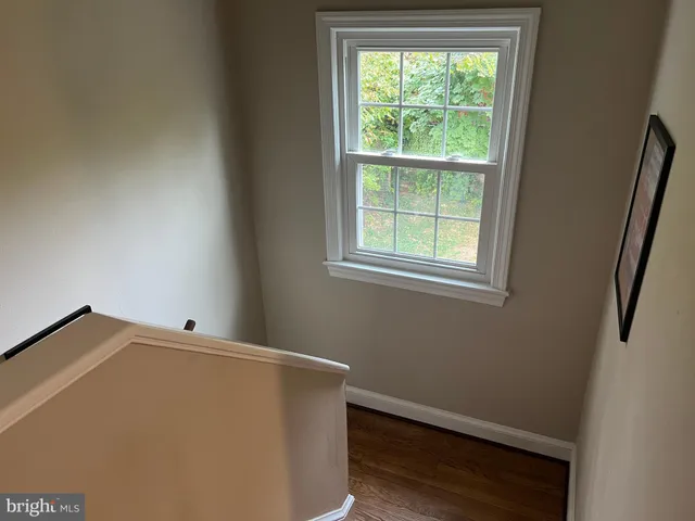 a view of workspace with wooden floor windows