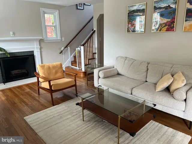 a living room with furniture a rug and a fireplace