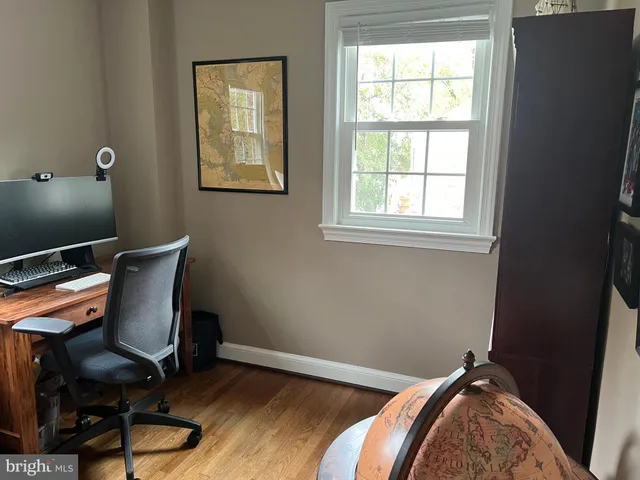 a room with a baby crib and a dresser