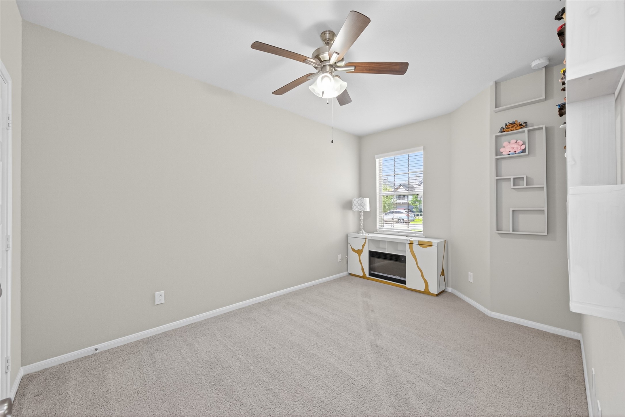 22409 Kinley Street New Caney, TX 77357 - Photo 39 of 46 an empty room with windows and fan
